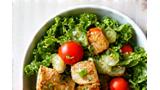 Thumbnail image of a person enjoying a balanced, colorful salad under natural light